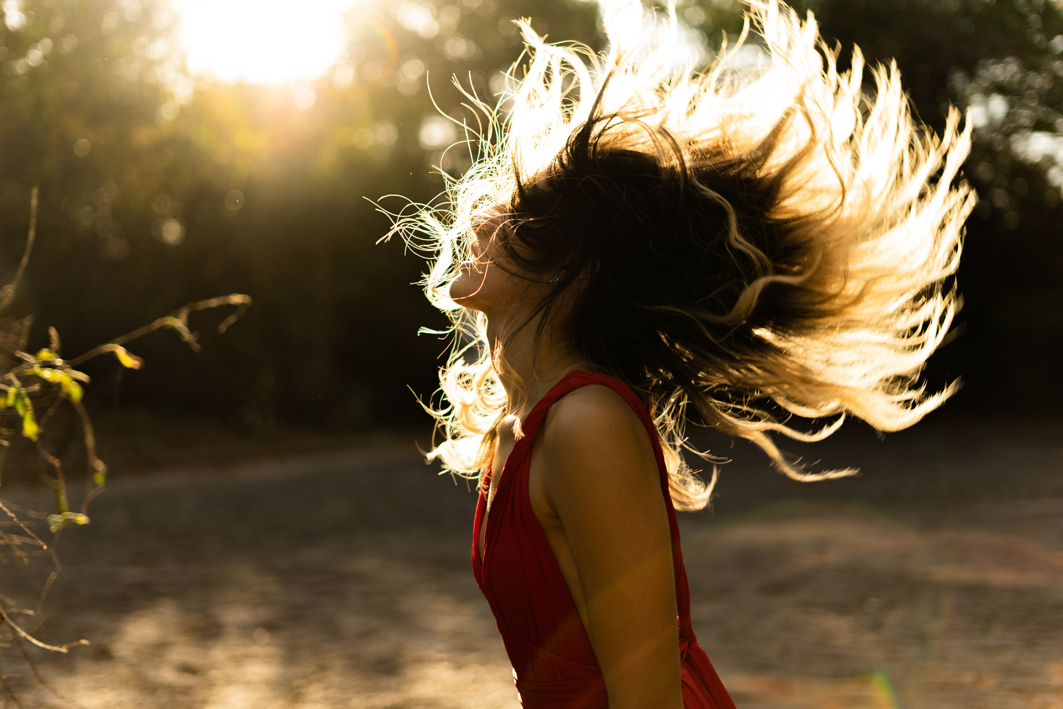 Woman in Red Sleeveless Top Flipping Hair